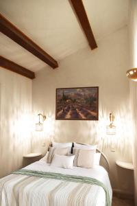 a bedroom with a large bed with two lights on it at Lou Cigalou - Au Calme - Grand Jardin - Piscine Partagée - Parking - Campagne et Idéalement Situé Proche A7 et Montélimar in Sauzet