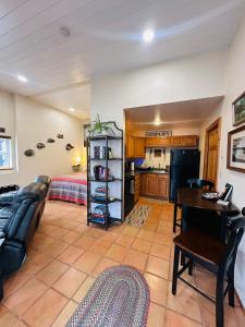 a living room with a couch a table and a kitchen at Henry Hollow Retreat Terrace in Eureka Springs