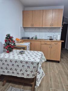 a kitchen with a table with a christmas tree on it at Cozy Central Studio - Dile in Žabljak