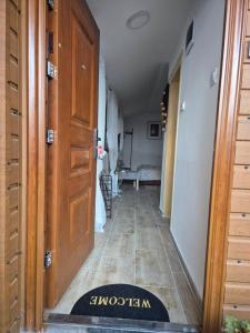 a hallway with a door and a rug on the floor at Cozy Central Studio - Dile in Žabljak