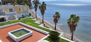 a house with a swimming pool next to the ocean at MARIA'S DREAM HOUSE in Eretria