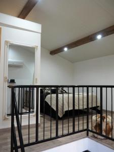 a bedroom with a bed and a railing in a room at Casa da Ti Paqueta in Sabugal