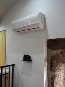 a white air conditioner hanging on a wall at Casa da Ti Paqueta in Sabugal