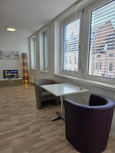 an office with a table and chairs and windows at Ganz Apartments in Fürth