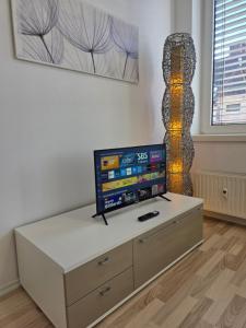 a living room with a tv on top of a table at Ganz Apartments in Fürth