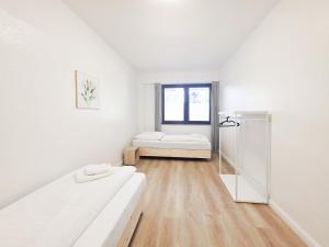 a white room with a bed and a window at Tolstov Apartments - 3 Room Apartment - Kitchen - Dining Area - 25 min Messe DUS in Duisburg