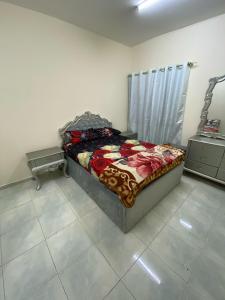 a bedroom with a bed in a room at AAP KA APPNA ROOm2 in Sharjah