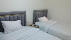A bed or beds in a room at Pyramids House inn