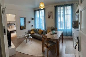 a living room with a couch and a table at Bright and renovated 2-room apartment, Center in Vitry-le-François