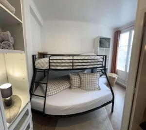 a bunk bed with pillows on it in a room at Bright and renovated 2-room apartment, Center in Vitry-le-François