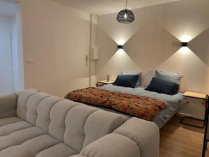 a living room with a couch and a bed at Appartement standing 500m de la plage ! in Dunkerque