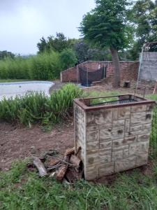 a wooden box sitting in the grass near a road at Vulindlela Mama Solutions in King Williams Town