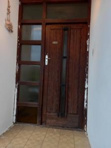 a wooden door in a room with a tile floor at Vulindlela Mama Solutions in King Williams Town
