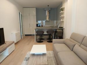 a living room with a couch and a kitchen at Charlie in Trebinje