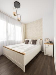 a bedroom with a large white bed in a room at AGIA 3-comfort apartment Sofia in Sofia