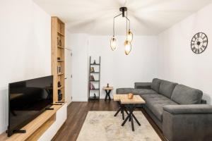 a living room with a couch and a table at AGIA 3-comfort apartment Sofia in Sofia