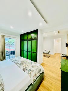 a bedroom with a large bed and a table at VALE MAR Guest in Ribeira Brava