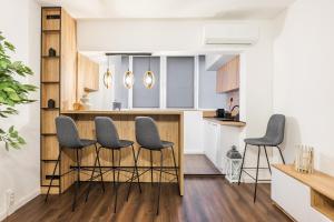 a kitchen with gray stools and a counter at AGIA 3-comfort apartment Sofia in Sofia