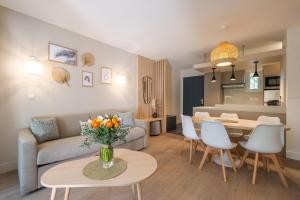 a living room with a couch and a table at Dolce Vita Plage et St Tropez - 10 in Saint-Tropez