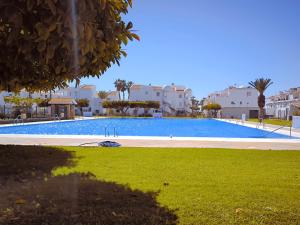 a large swimming pool in a park with buildings at Cayo Beach in Torrox Costa