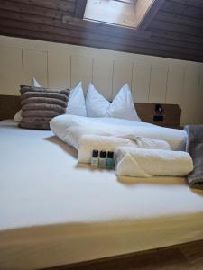 a bed with towels and pillows on top of it at Haus Marinus in Jerzens