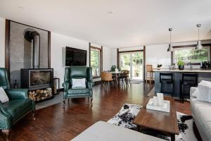 a living room with a couch and a fireplace at Blue House On The Hill - Year Round Cottage in Turriff