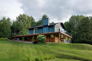 a blue house on top of a green field at Blue House On The Hill - Year Round Cottage in Turriff
