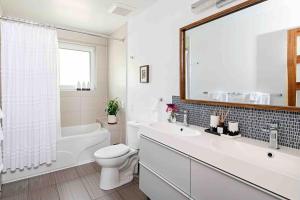 a white bathroom with a tub and a toilet and a sink at Blue House On The Hill - Year Round Cottage in Turriff +103 photos