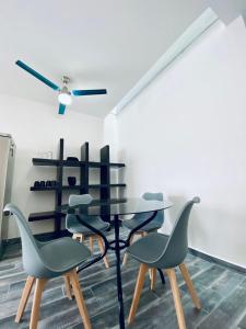 a dining room with a black table and chairs at Departamento Arrecife in La Paz