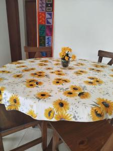 a table with a table cloth with sunflowers on it at Encanto de Lozano in Lozano