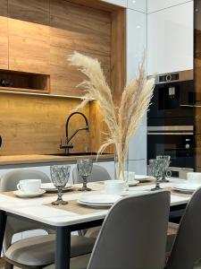 a kitchen with a table with chairs and a sink at Apartment in Boulevard in Tashkent