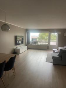 a large living room with a couch and a table at A two-story apartment with three bedrooms in Trondheim