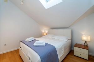 a bedroom with a bed with towels on it at Boutique Apartment Ana in Dubrovnik