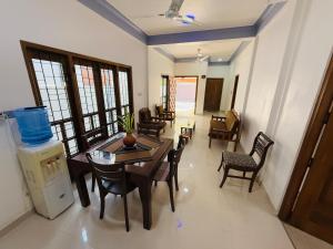 a living room with a dining room table and chairs at Birds Nest in Trincomalee