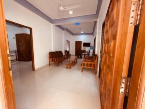 a view of a living room with a couch and chairs at Birds Nest in Trincomalee +23 photos