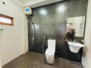 a bathroom with a toilet and a sink at Birds Nest in Trincomalee
