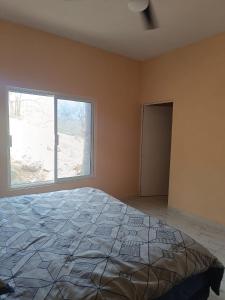 a bedroom with a large bed and a window at Casa paraiso in Maito