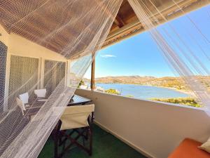 a room with a desk and a view of the ocean at Sea Lullaby in Drymonas