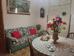 a living room with a table and a couch at Casa Eloisa - Le Case di Bettina in San Fratello