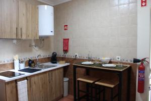 a kitchen with a sink and a counter top at Carmo guestroom in Tabuaço