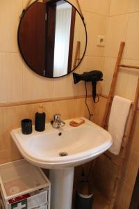 a bathroom with a sink and a mirror at Carmo guestroom in Tabuaço +11 photos