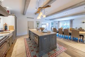 an open kitchen and dining room with a large island at Beautiful property near Fayence in Saint-Paul-en-Forêt