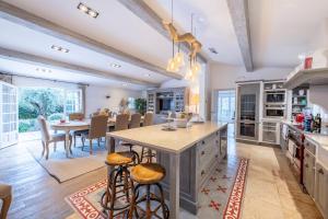 a kitchen with a large island and a table with bar stools at Beautiful property near Fayence in Saint-Paul-en-Forêt
