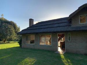a house with a solar roof on a yard at La Calma casa quinta in Capilla del Señor +19 photos