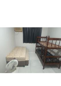 a room with a bed and a bench and a shelf at Casa raízes do bem in São Pedro da Aldeia +25 photos