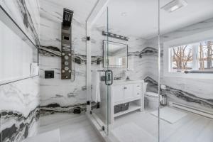 a white bathroom with a shower and a sink at Tranquility Redefined in the Heart of the Catskills in Jewett +100 photos