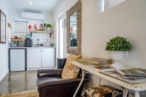 a living room with a couch and a table at The Hedge Cottage in Riebeek-Kasteel