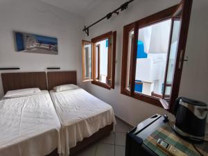Postel nebo postele na pokoji v ubytování Maria Eleni Guesthouse