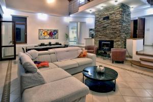 a living room with a couch and a fireplace at Villa Margarita in Polis Chrysochous