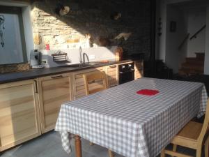 a kitchen with a table with a checkered table cloth at La Grange de Fanie in Odeigne
